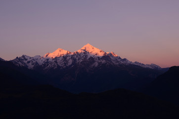 Peaks of the Caucasus Mountains on the background of purple sky