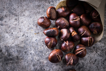 Roasted chestnuts on an old board. healthy food concept