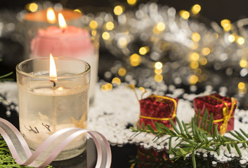 Christmas gift box with fir and decor on glitter background