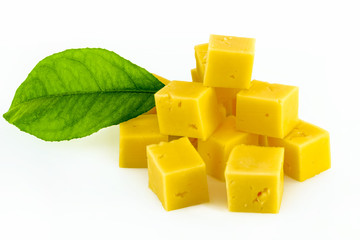 Cube of cheese isolated on a white background.