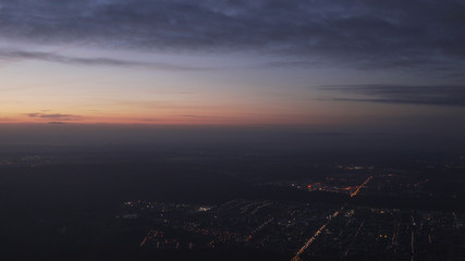 Fototapeta premium handheld shot flying on airplane over night citys grainy