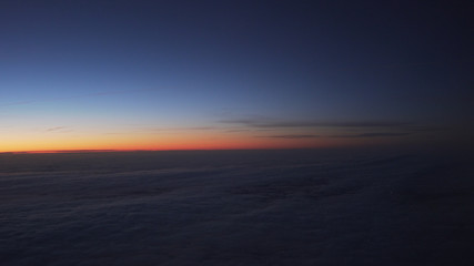 Fototapeta premium clouds in early morning during flight on a plane