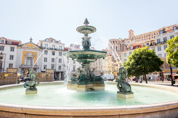 Fototapeta na wymiar Beautiful view on the fountain on the Rossio square during the sunny day in Lisbon city, Portugal