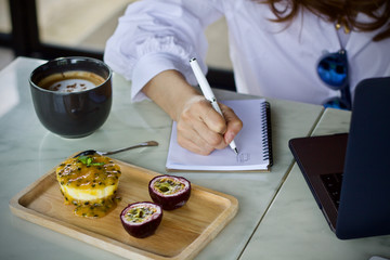 Woman writing working using laptop online