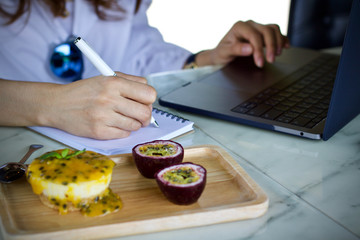 Woman writing working using laptop online