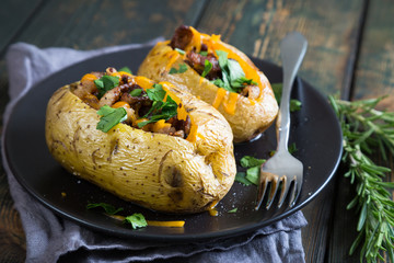 Baked potatoes with bacon and fresh herbs
