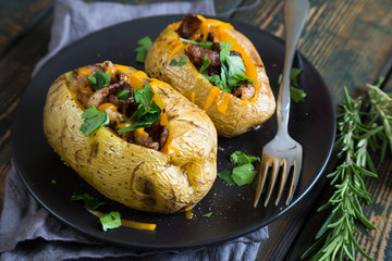 Baked potatoes with bacon and fresh herbs