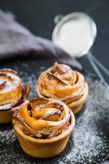 Fresh muffins with an apple