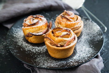 Fresh muffins with an apple