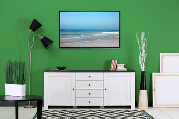 Room interior with TV stand on color wall background