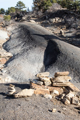 Trail marker cairn and black dirt trail of Raider's Ridge in Durango, Colorado