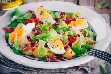 potato salad with eggs, lettuce,  tomatoes and bacon