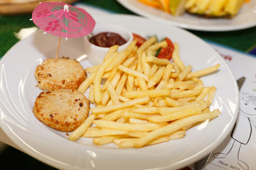 French fries with cutlets on the white plate