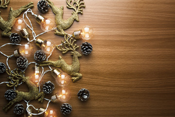 flat lay of gold color reindeer and bead with pine cone decoration in christmas concept