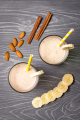 Banana milk smoothie with almonds and cinnamon. Top view