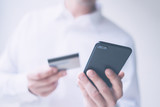 Man with smartphone and credit card