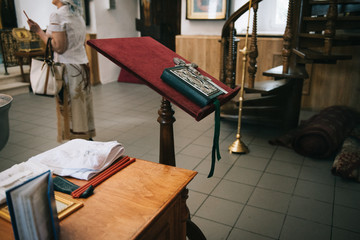Golden religious utensils - Bible, cross, prayer book, missal. Details in the Orthodox Christian Church. Russia.