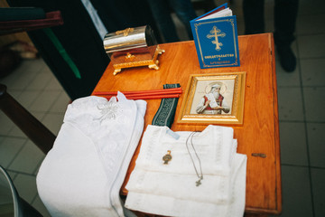 Golden religious utensils - Bible, cross, prayer book, missal. Details in the Orthodox Christian Church. Russia.