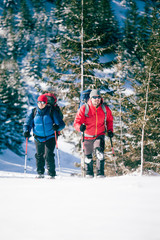 Two climbers are in the mountains.