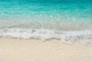 Fototapeta na wymiar Teal blue warm sea waves shallow on white sand. Tropical beach seaside vacations. Laccadive sea resort. 