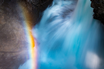 Close up view of waterfall with rainbow