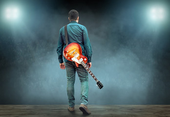 Artist Guitarist hands play on electricity guitar under light, P