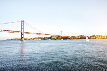Landscape view on the 25th of April Bridge during the sunset in Lisbon city, Portugal