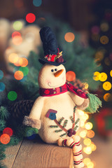 Christmas toy snowman in the background gifts and lights, Christmas card