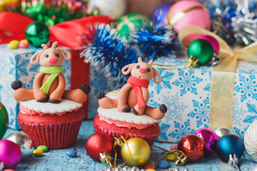 Christmas cupcakes with colored decorations made from confectionery mastic