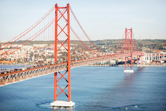 Landscape view on the Tagus river and the famous 25th of April Bridge during the morning light in Lisbon city, Portugal