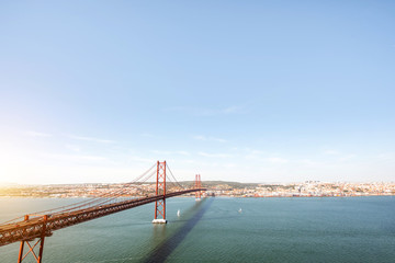 Wide angle landscape view on the Tagus river and the famous 25th of April Bridge in Lisbon city, Portugal