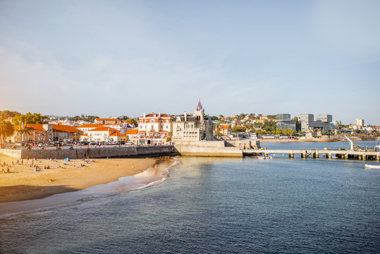 Sunset view on the beach with Palmela palace in Cascais resort in Portugal