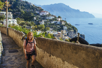 woman hikes along the amalfi coast with nice view tho the Mediterranean Sea/ Amalfi, italy, europe
