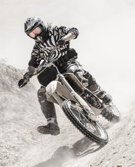 motocross rider on a dusty road 