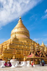 Naklejka premium Bagan, Myanmar - December 6, 2014: Burmese people pray and worship at Shwezigon Paya, one of Myanmar's most revered pagodas, in Bagan, Myanmar (Burma).