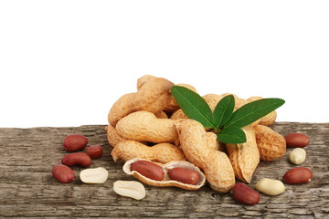 peanuts with leaf on old wooden background