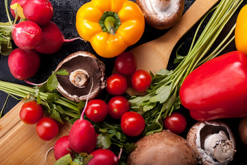 Delicious fresh vegetable on dark wooden background in close up image