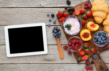 Morning meals and smartphone on rustic wooden table