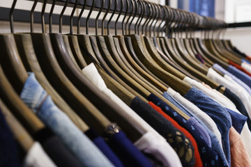 Fototapeta premium Jeans of different styles on the hanger in the showroom.