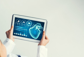 Close of female doctor hands working with tablet pc computer