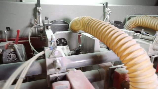 edge banding machine. The machine for facing the edges of furniture parts. The work of the edge banding machine. Furniture manufacture.