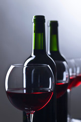 Bottles and glasses of red wine.