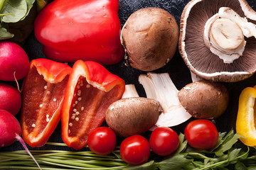 Close up photo on healthy organic vegetables lying on dark wooden table
