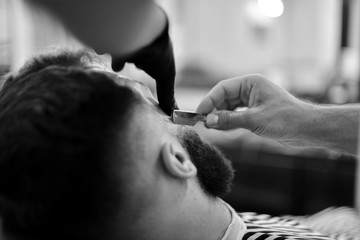 Obraz na płótnie Canvas Correction of beard and haircuts in barbershop. Haircut of a man.