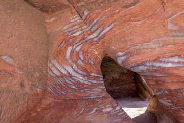 Veins of different shapes, colors and shades on the red rocks of the Royal Tombs of Petra, Jordan, Midle East