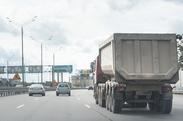 A lorry with tipping trailer in motion on the motorway.