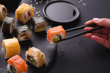 Eating sushi at restaurant, japanese cuisine