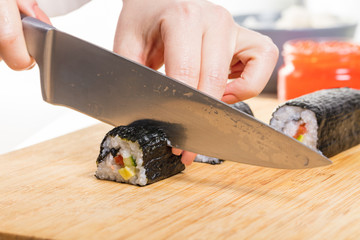 Chef cuts rolls, hands close-up