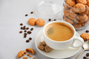 Cup of fresh coffee with Amaretti cookies on gray concrete or stone background, selective focus, copy space