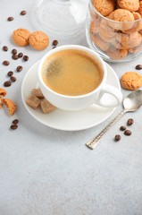 Obraz na płótnie Canvas Cup of fresh coffee with Amaretti cookies on gray concrete or stone background, selective focus, copy space